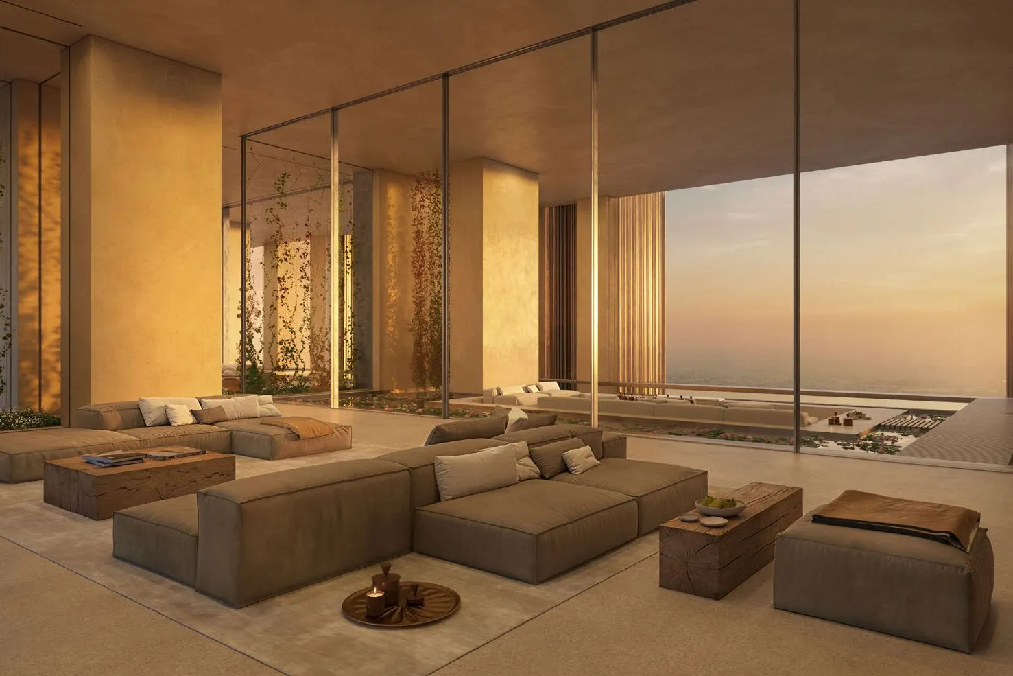 Spacious living room with deep sofas and sunset views through glass